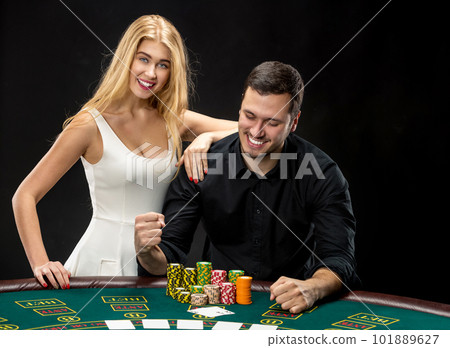 Young couple playing poker have a good time in casino Young couple playing poker have a good time in casino 101889627