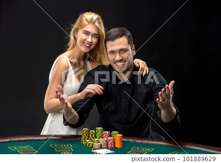 Young couple playing poker have a good time in casino Young couple playing poker have a good time in casino 101889629