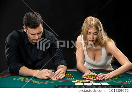 Poker players sitting at poker table and going all-in 101889672