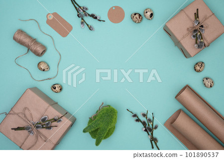 Frame of gift box, willow tree branch, jute rope, wrapping paper roll and gift tags. Easter, spring, holiday concept. Flat lay, copyspace. Frame of gift box, willow tree branch, jute rope, wrapping paper roll and gift tags. Easter, spring, holiday concept. Flat lay, copyspace. 101890537