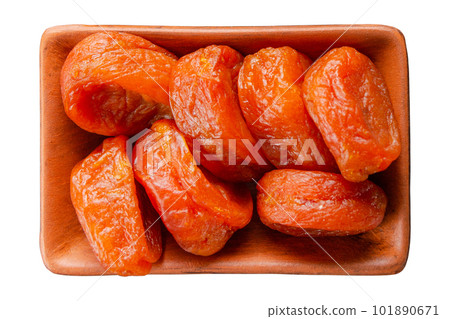 Dried apricots in clay bowl isolated on white flat lay view Dried apricots in clay bowl isolated on white flat lay view 101890671