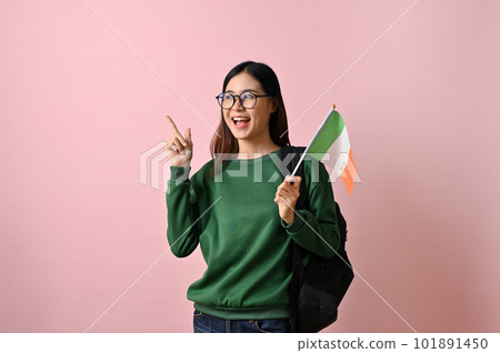 Smiling Asian female college student holding a flag of India and pointing her finger up Smiling Asian female college student holding a flag of India and pointing her finger up 101891450