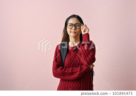 Smart, pensive and thoughtful young Asian female college student touching her glasses Smart, pensive and thoughtful young Asian female college student touching her glasses 101891471