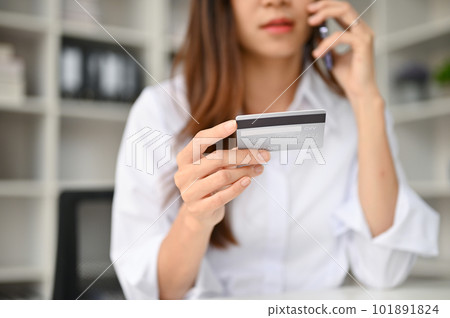 Close-up image of a young Asian female contacts a credit card call-center service 101891824