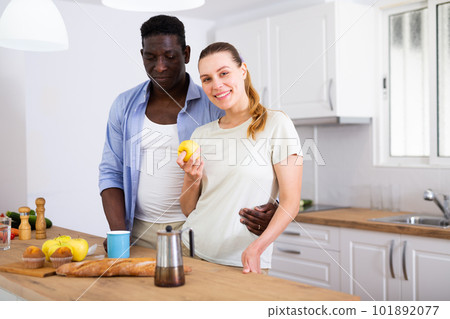 Loving couple drinking morning coffee and talking in home kitchen 101892077