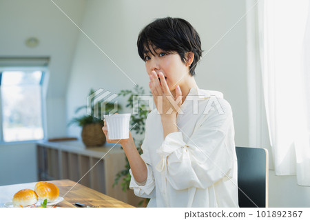 A woman eating breakfast A woman eating breakfast 101892367
