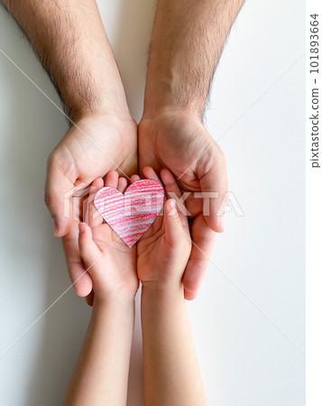 adult and childrens hands hold small red paper heart. Fathers Day. Family, love adult and childrens hands hold small red paper heart. Fathers Day. Family, love 101893664