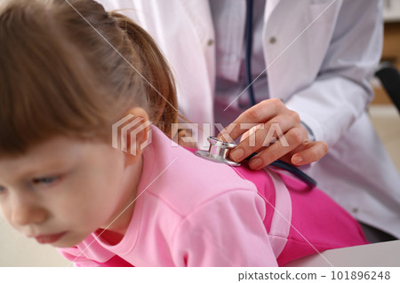 Little girl at doctor lung area examined with stethoscope Little girl at doctor lung area examined with stethoscope 101896248