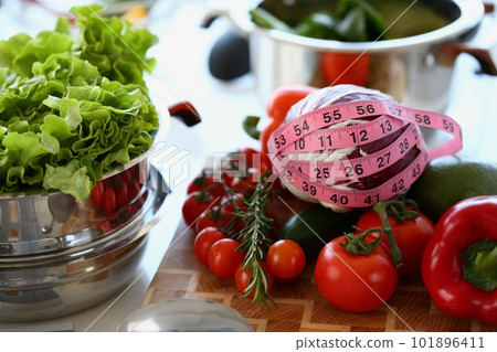 Fresh juicy vegetables with measuring tape closeup Fresh juicy vegetables with measuring tape closeup 101896411