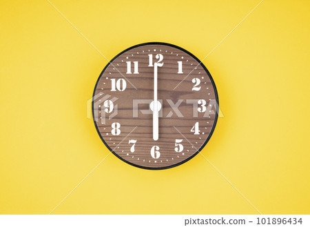 The Retro wooden clock at 6 O' clock on yellow color background. 101896434