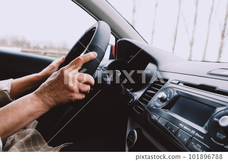 cropped photo of hands on wheel of old woman cropped photo of hands on wheel of old woman 101896788