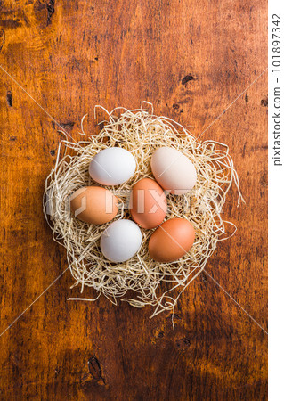 Whole chicken eggs on wooden table. Top view. 101897342