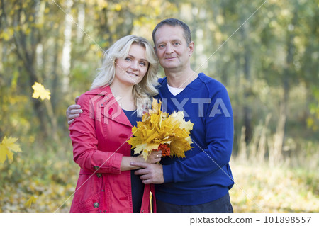 Loving couple in the autumn park. Spouses of middle age for a walk.Man and women hugging 101898557