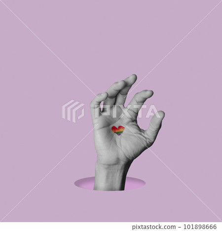 heart-shaped rainbow pride flag in a hand heart-shaped rainbow pride flag in a hand 101898666