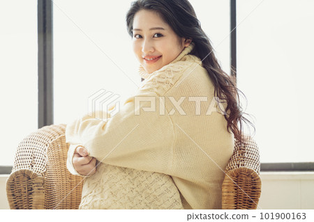 Portrait of a woman wearing a knitted dress Portrait of a woman wearing a knitted dress 101900163