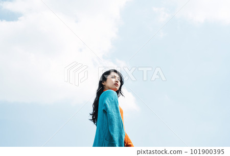 young woman looking up at the sky young woman looking up at the sky 101900395