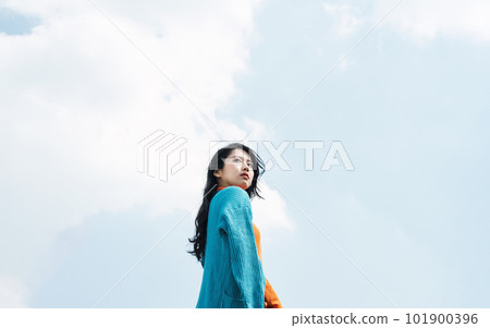 young woman looking up at the sky young woman looking up at the sky 101900396