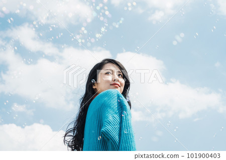 young woman looking up at the sky young woman looking up at the sky 101900403