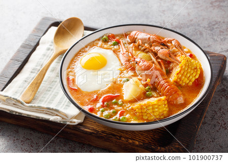 Crayfish soup with tomatoes, corn, pepper, potato and egg close-up in a bowl. Horizontal Crayfish soup with tomatoes, corn, pepper, potato and egg close-up in a bowl. Horizontal 101900737