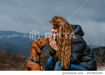 Woman and Dog Looking at Each Other in Mountains Woman and Dog Looking at Each Other in Mountains 101902084