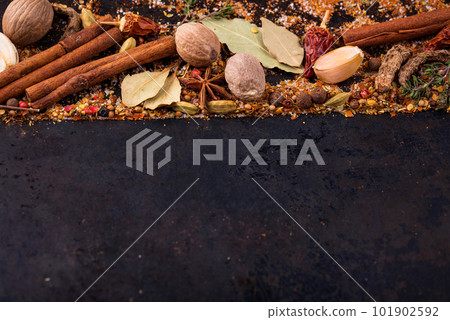 Different spices and herbs on a black background 101902592