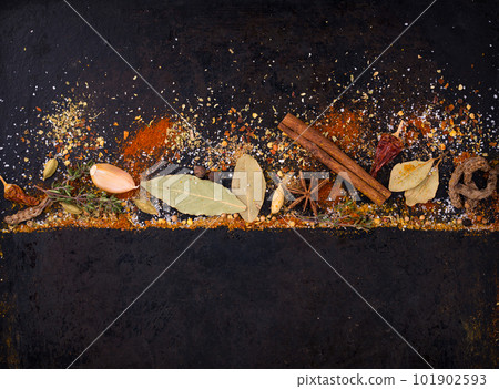 Different spices and herbs on a black background Different spices and herbs on a black background 101902593