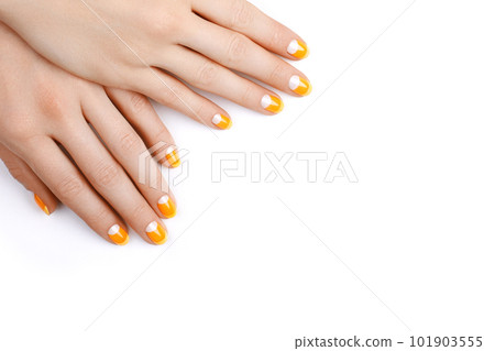 Beautiful Female Hands with bright orange Manicure like Candy Corn. Manicured Nails with Yellow Gel Polish. Halloween Style Beautiful Female Hands with bright orange Manicure like Candy Corn. Manicured Nails with Yellow Gel Polish. Halloween Style 101903555