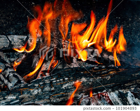 Orange flames of fire of a wood fire. 101904893