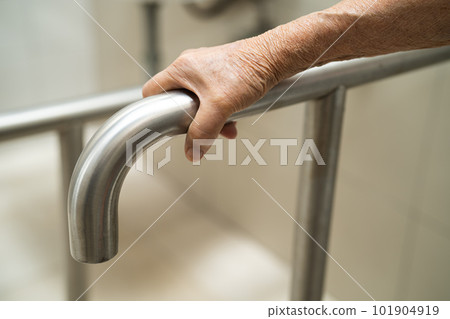 Asian elderly woman patient use toilet bathroom handle security in nursing hospital, healthy strong medical concept. 101904919