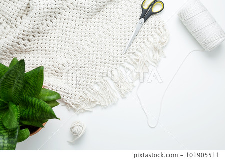 Creative hobby handmade macrame for home decoration. Weaving macrame at home. Tools and materials for macrame weaving. Flat lay, top view Creative hobby handmade macrame for home decoration. Weaving macrame at home. Tools and materials for macrame weaving. Flat lay, top view 101905511