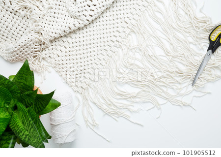 Creative hobby handmade macrame for home decoration. Weaving macrame at home. Tools and materials for macrame weaving. Flat lay, top view Creative hobby handmade macrame for home decoration. Weaving macrame at home. Tools and materials for macrame weaving. Flat lay, top view 101905512