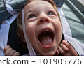 A little boy looks out of the tent window, he is having a lot of fun 101905776