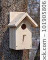 CLoseup of a birdhouse on a tree stem 101905806