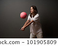 Serious teen girl hits the basketball ball 101905809
