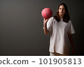 Serious teen girl with baseketball ball 101905813