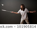 Girl holding training badminton on a dark background 101905814