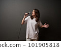 Emotional young woman singing in mic 101905818