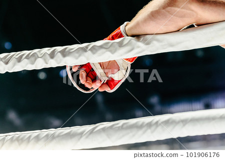 fighter hand in red glove lies on white rope ring 101906176