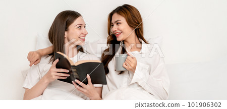 Young asian couple woman reading literature or a book together a Young asian couple woman reading literature or a book together a 101906302