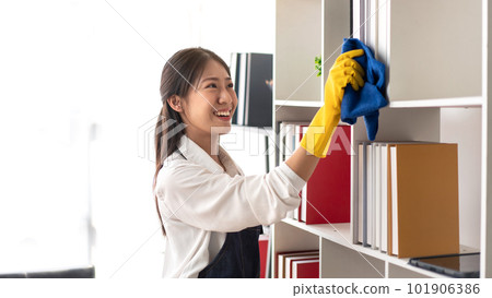 Housewife in apron wearing gloves to using microfiber fabric to Housewife in apron wearing gloves to using microfiber fabric to 101906386