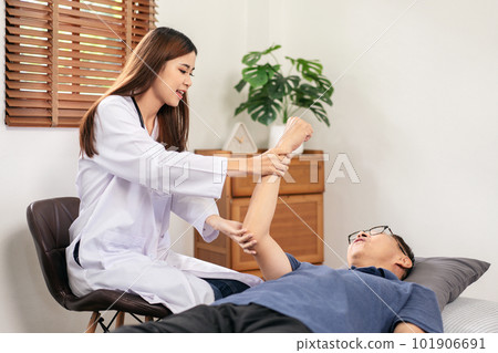 Female physical therapist working and doing arm rehabilitation t Female physical therapist working and doing arm rehabilitation t 101906691