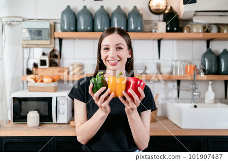 Woman holding colorful bell pepper in her hands with enjoying wh 101907487