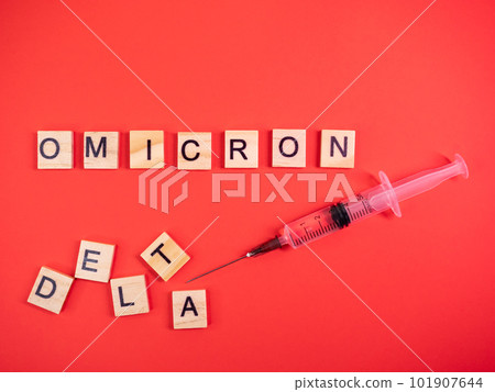 Omicron variant replaces Delta. Emergence of new dangerous strain of coronavirus COVID-19 Omicron. Syringe. Words omicron delta on colored red background 101907644