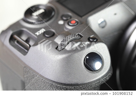 Close up top panel of hi-end Digital Camera, Mirrorless Digital Camera, show on camera mode command functional dial, shutter release button, Video record, multi function button. Close up top panel of hi-end Digital Camera, Mirrorless Digital Camera, show on camera mode command functional dial, shutter release button, Video record, multi function button. 101908152