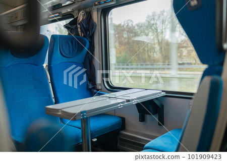 Interior of a modern intercity express train. Back view of wide comfortable seats in row at railroad transport. Empty salon, no passengers. Travel concept. High quality photo Interior of a modern intercity express train. Back view of wide comfortable seats in row at railroad transport. Empty salon, no passengers. Travel concept. High quality photo 101909423