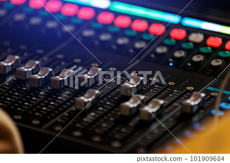 Concert sound mixer panel with volume regulators. Professional audio and light equipment for sound recording studio, live music broadcasting, television, party. mixing console. audio signals 101909684