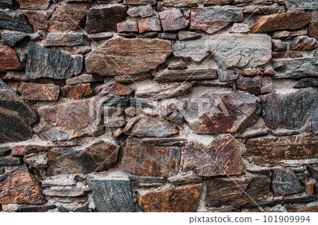 Old stone wall at the castle ruins. Texture of old weathered medieval stone wall Old stone wall at the castle ruins. Texture of old weathered medieval stone wall 101909994