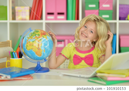 girl studying with a globe at the table girl studying with a globe at the table 101910153