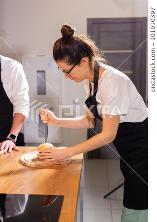 Preparing delicious burgers. Chef cooking meat burgers with beef, cheese and vegetables. 101910397