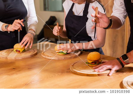 Chef teaching trainees how to make ice cream. Cooking tasty ice cream dessert made from chocolate and vanilla in glass bowl 101910398
